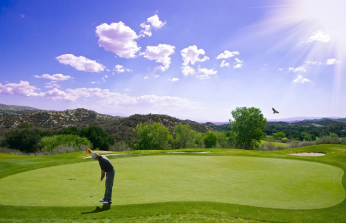 Man playing golf on a sunny day